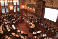 Blick von oben auf Teilnehmende im Grossratssaal Basel-Stadt am Anlass Willkommen in Basel.(Copyright Juri Weiss))
